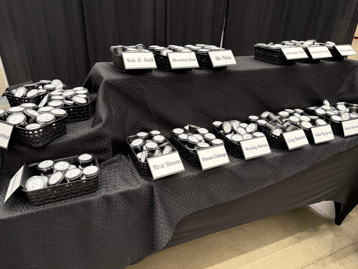 Downing Avenue Wax Melt Bar set up at a market, wax melt jars sorted by scent